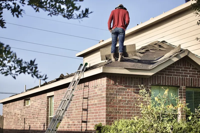 Professional roofer working on a residential roof in Burr Hill